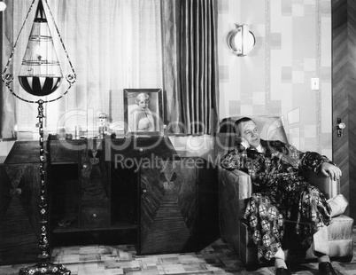 Man in a robe sitting on a chair