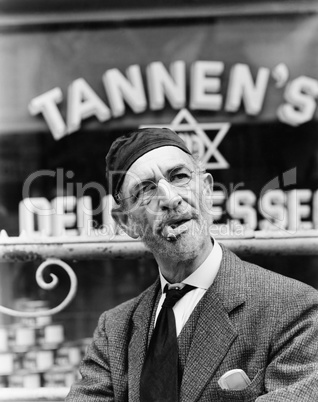 Jewish man standing in front of a storefront