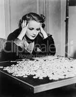 Young woman trying to solve a puzzle