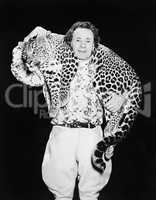 Man posing with a leopard around his neck