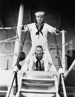 Two sailors standing on a gangway
