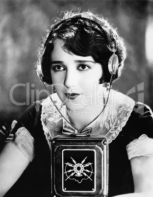 Woman wearing headphones with a microphone in front of her