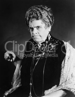 A very stern looking woman holding onto her cane