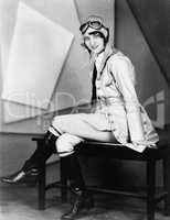 Woman sitting on a bench in a pilots uniform