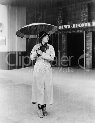 Woman in a raincoat and umbrella