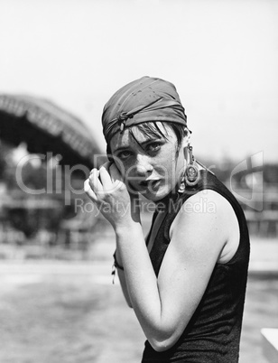 Portrait of a woman wrapping a scarf on her head