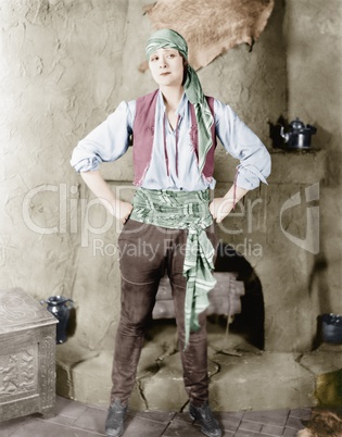 Woman standing in front of a fireplace in a pirates costume