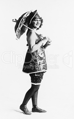 Woman posing in a dress with a sun umbrella