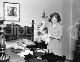 Woman in her bedroom sorting her gloves