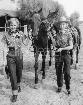 Two women with their horses