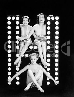 Three young women posing with the letter H