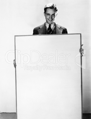 Portrait of a businessman holding a poster and smiling