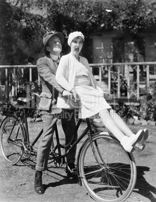 Couple sitting on a tandem bicycle