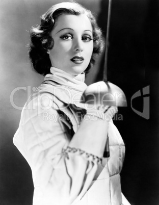 Portrait of a young woman holding a fencing foil