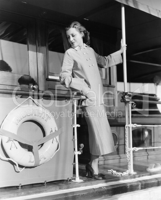 Young woman standing at the railing of a boat