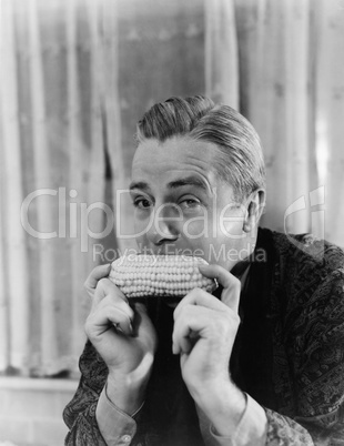 Portrait of a man eating a corn cob