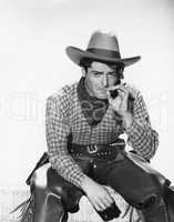 Cowboy with a cowboy hat smoking a cigarette