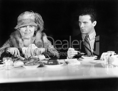 Woman and young man sitting at a coffee counter