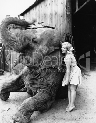 Profile of a young woman hugging an elephant