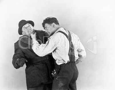 Two men fighting with each other
