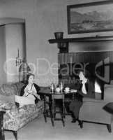Two women drinking tea and talking