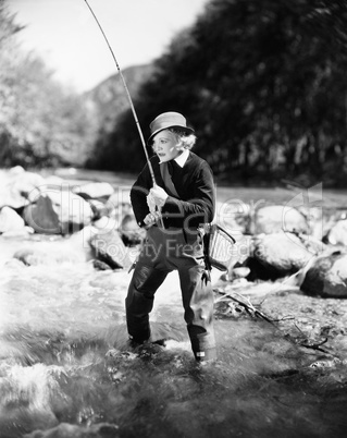 Young woman fishing in river