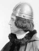 Portrait of a man in costume and a helmet looking away