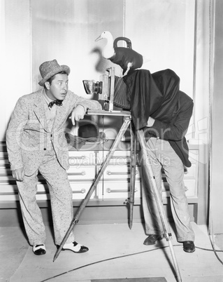 Photographer taking a picture of a young man