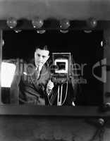 Portrait of a man standing with a large format camera