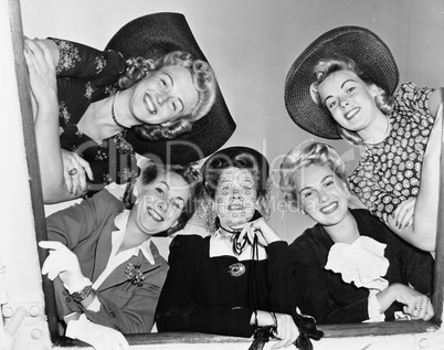Portrait of five young women smiling and looking down
