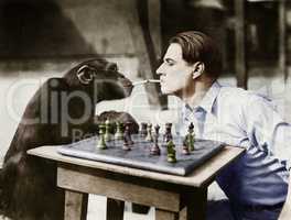 Profile of a young man and a chimpanzee smoking cigarettes and playing chess