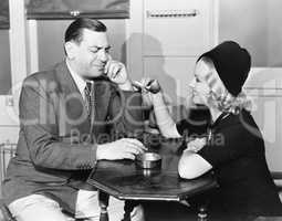 Profile of a man with a young woman smoking sitting in a cafe