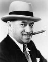 Portrait of a man with a hat and a cigar in his mouth