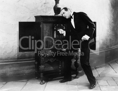 Man listening and dancing to music from a radio