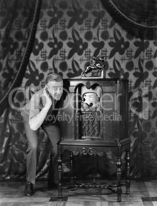 Portrait of a man listening to music from a radio and smiling