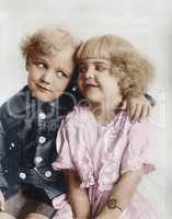Portrait of a boy and girl with arm around her