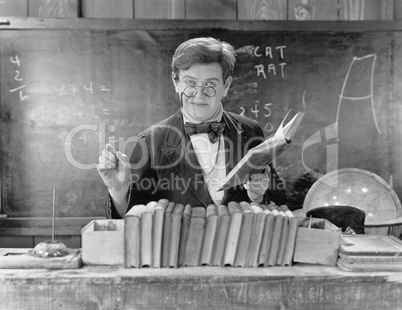 Man with glasses teaching in a classroom