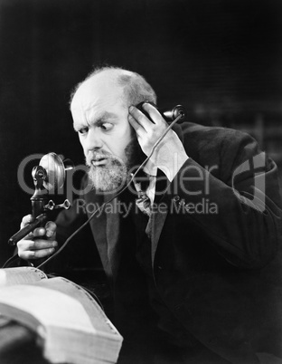 Man talking on the telephone looking intense