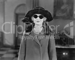 Portrait of woman in hat, sunglasses and coat