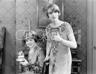 Two woman standing together in the living room