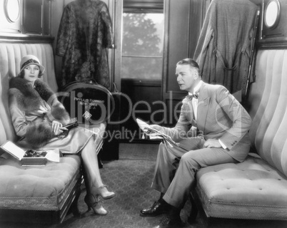 Couple sitting together in a compartment of a train