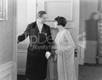 Elegant couple standing in the doorway