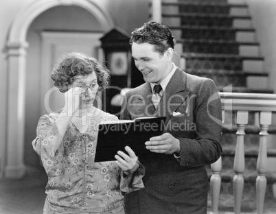 Couple looking at a book together