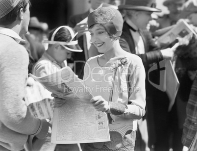 Elegant woman reading a newspaper