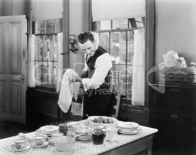 Man standing in the kitchen cooking a meal