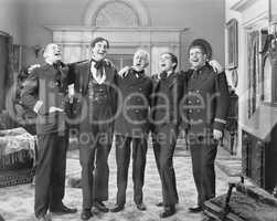 Five men standing together singing