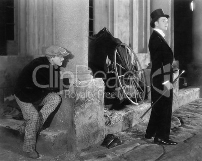 Man in formal attire being stalked by a burglar