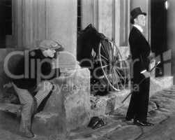 Man in formal attire being stalked by a burglar