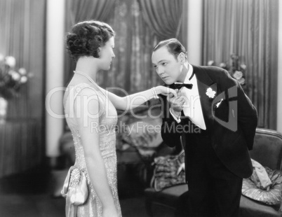 Young man kissing an elegant woman's hand