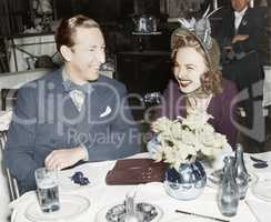 Couple sitting together at a table having fun